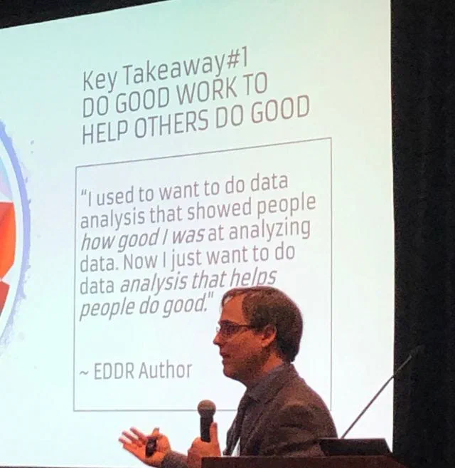 This photograph shows a speaker, identified as EDDR Author Jared Knowles, at a conference. A slide behind him reads 'Key Takeaway #1: DO GOOD WORK TO HELP OTHERS DO GOOD,' and includes a quote about shifting focus from analyzing data to helping people do good.