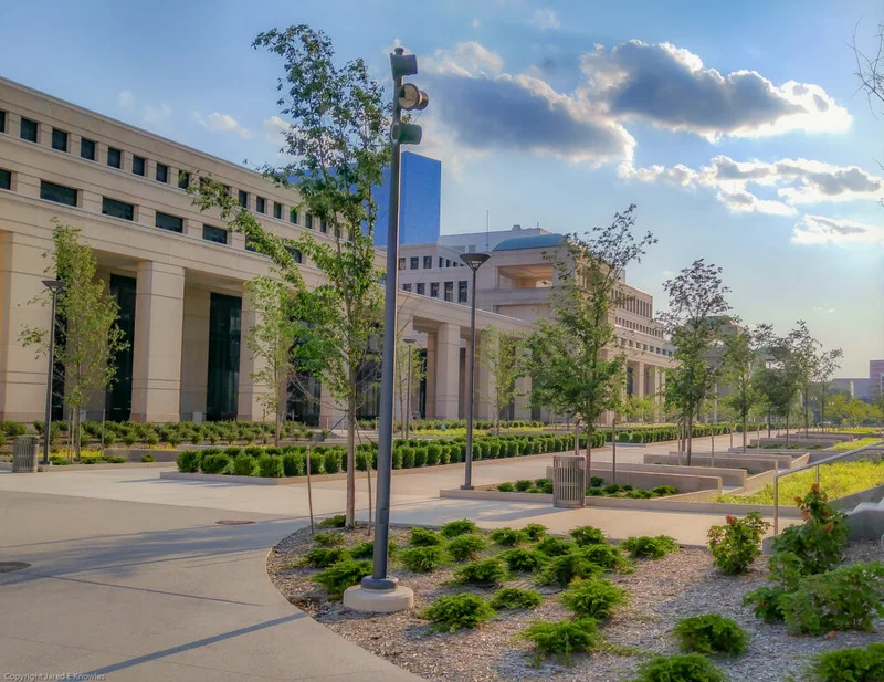 This photograph shows a modern, neoclassical building with large columns and landscaping in front of it. The image illustrates the kind of institutional setting where accountability systems are developed and implemented.